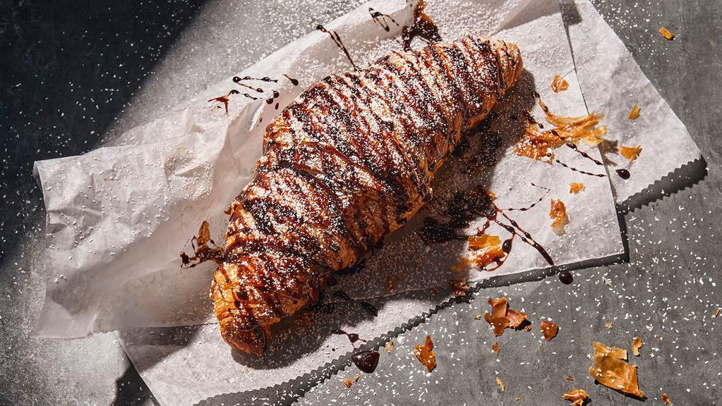 Chocolate Croissant · 380 Cal. A freshly baked, perfectly flaky butter croissant stuffed with chocolate flavored cream cheese and topped with a chocolate flavored drizzle and powdered sugar. Allergens: Contains Wheat, Soy, Milk, Egg