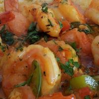 Shrimp & Grits · Grits with Blackened Prawns and topped with Sauteed Green and Red Peppers.
