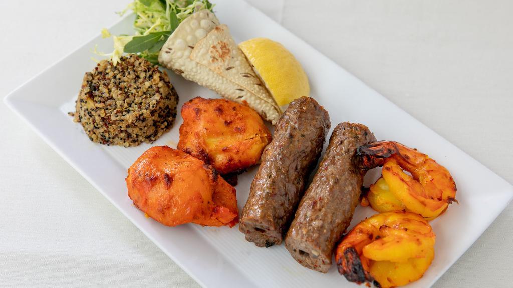 Tandoori Sampler · Gluten-free. Nawabi chicken, lamb seekh kebab and zaffrani jhinga. Served with organic buckwheat pilaf.