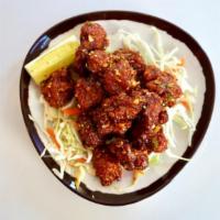 Gochujang Popcorn Chicken · Gochujang Marinated Popcorn Sized Fried Chicken Pieces, with Spicy Garlic Chips & Toasted Se...