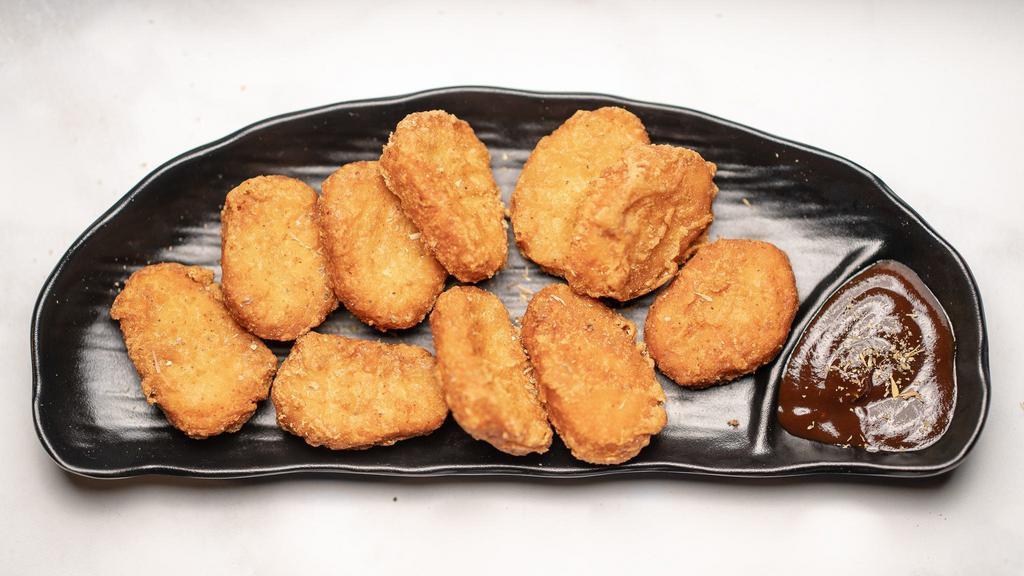 Connoisseur's Chicken Nuggets · Farm chicken breasts battered and lightly fried until golden crisp. Served with hot sauce.