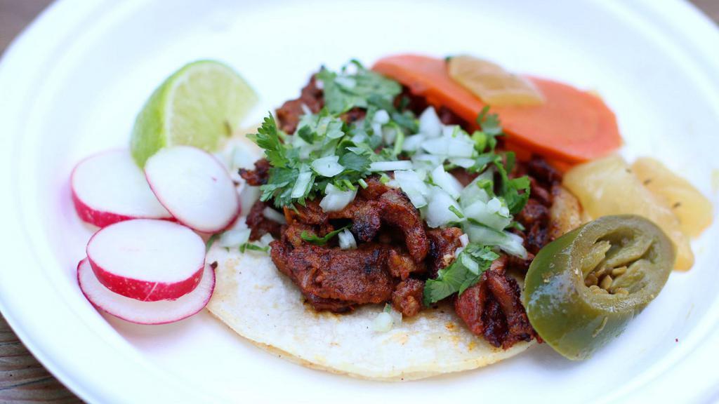 Regular Taco · Corn tortilla, your choice of meat, onions and cilantro. Served with limes and radish.