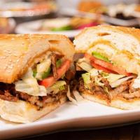Torta El Bombon · Refried beans, Asada and Chorizo meat with pineapple, grilled onions, mushrooms, bell pepper...