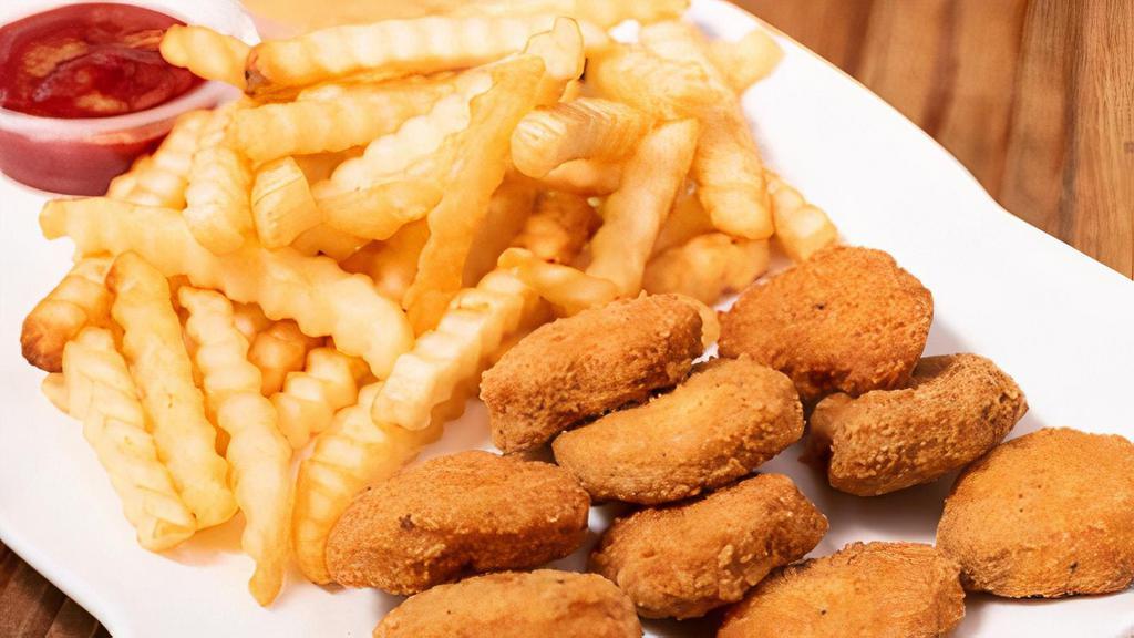 Chicken Nuggets · Chicken nuggets with french fries or rice and beans on the side.