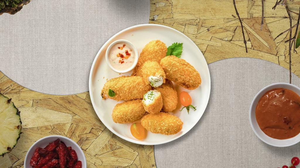 Jalapeno Poppers · Golden deep-fried jalapeños filled with cream cheese.
