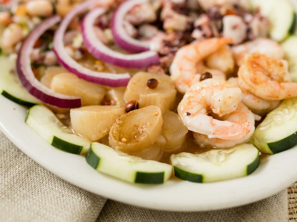 Botana Mazatlan · Cooked shrimp, raw pickled shrimp, scallops, octopus and shrimp ceviche topped with imported chiltepin roasted peppers and house black sauce.