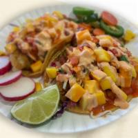 Mango Habanero Taco · Tempura Style Fish, topped with fresh mango, pico de gallo, cabbage and spicy house dressing...