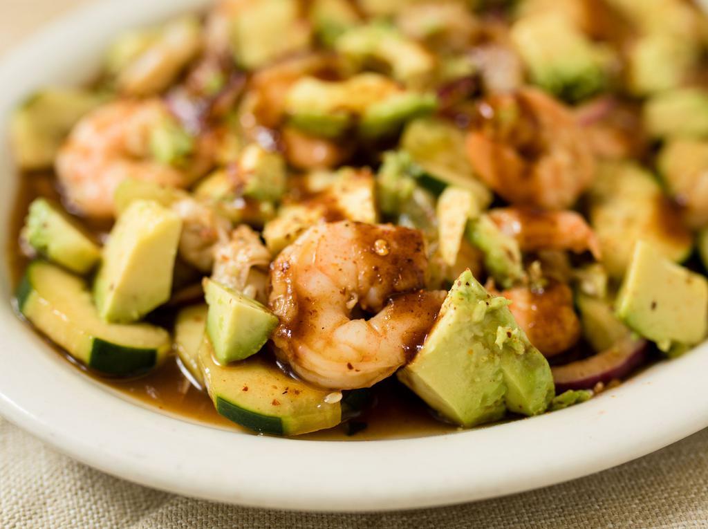 Aguachile El Tamarindo · Raw shrimp and cooked shrimp pickled in lime juice. Tossed with choice of sauce, cucumber and onion, topped with avocado, house sauce & chili powder.