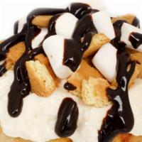 Campfire S'Mores Roll · marshmallow frosting topped with marshmallows, graham crackers, and chocolate sauce