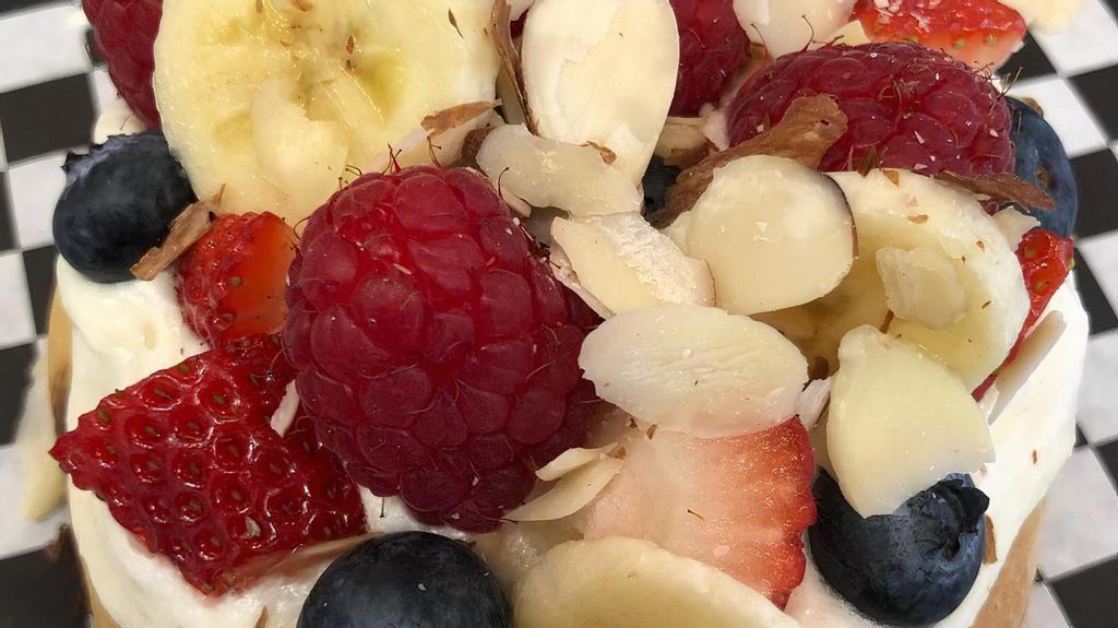 Tutti Frutti · Almond frosting topped with strawberries, blueberries, raspberries, bananas, and almonds.