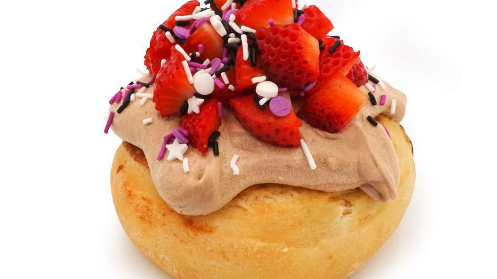 Sparkle Berry Roll · chocolate frosting topped with sprinkles and fresh strawberries (sprinkle colors may vary)