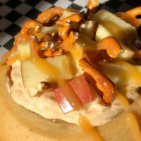 Apple Basket · Peanut Butter frosting topped with apples, pretzels, and caramel sauce.