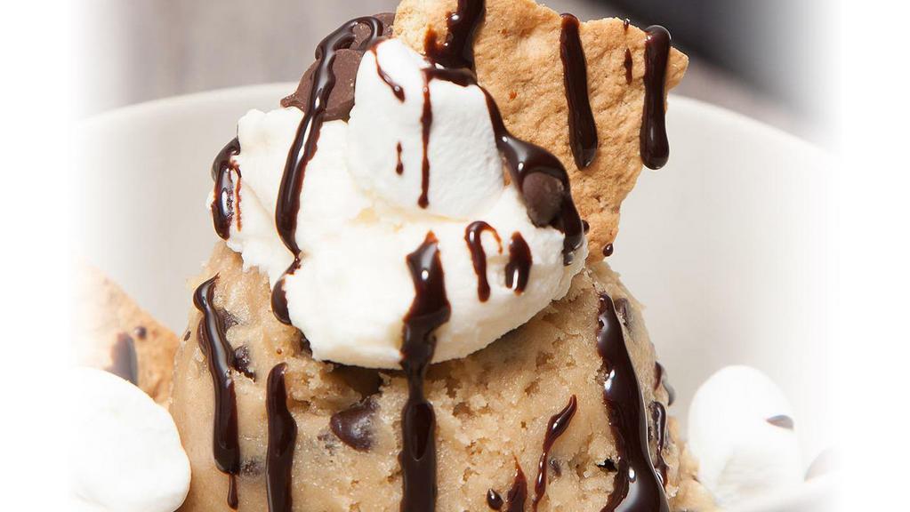 Cookie Dough Scoop -  S'Mores · our homemade cookie dough topped with a dollop of marshmallow frosting, marshmallows, graham cookies and chocolate sauce