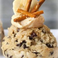 Salted Elvis Cookie Dough Scoop · Chocolate Chip Cookie Dough Scoop with Peanut Butter frosting topped with bananas and pretze...