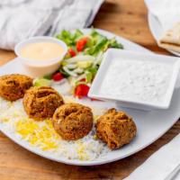 Vegetarian Platter · Two fresh falafels and two dolmas, along with Baba ghanoush and hummus, Greek salad and warm...