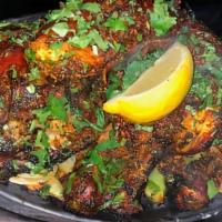 Tandoori Mix Grill · Kabob consisting of chunks of lamb, prawns, and chicken that are soaked in a mixture of yogu...
