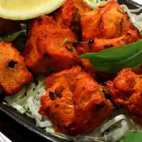 Tandoori Fish · Fish marinated in our special tangy sauce, served on a skillet