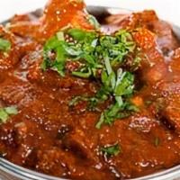 Goat Masala · Goat meat on the bone cooked with tomatoes and onions in curry sauce
