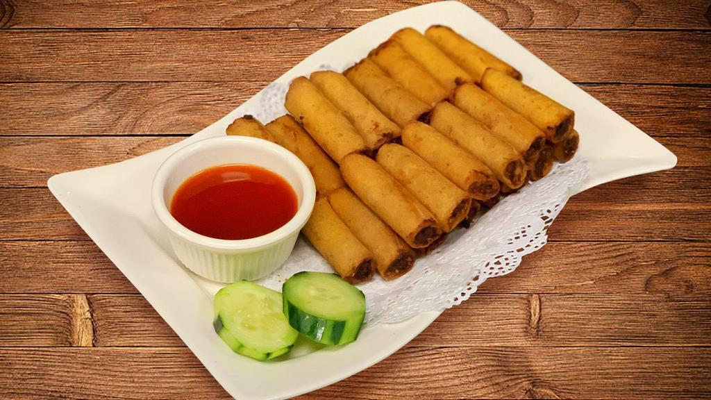 Lumpiang Shanghai · Pork filled fried egg roll with sweet and sour sauce on the side