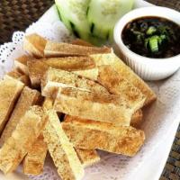 Crispy Tofu Fries · Fried tofu sticks with vinegar on the side