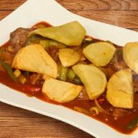 Beef Kalderata · Beef braised in tomato sauce with olives, pickles and potatoes.