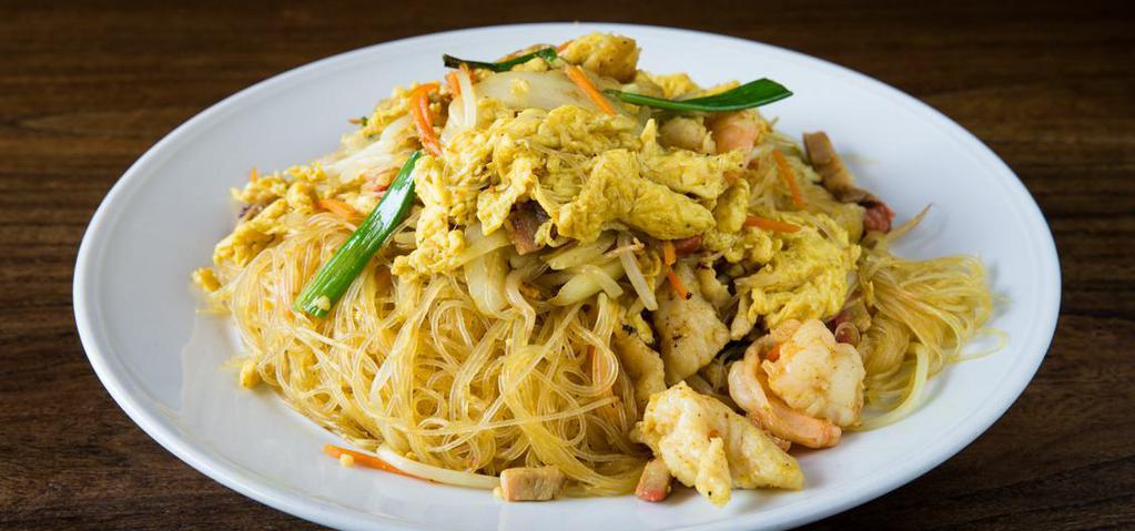 Singapore Noodles · Stir-fried vermicelli rice noodles in curry sauce with shrimps, chicken, pork, vegetables and egg.