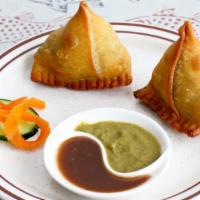 Vegetable Samosa (2) · Vegan. Peas and potatoes wrapped in our home-style samosa. bread and deep-fried.