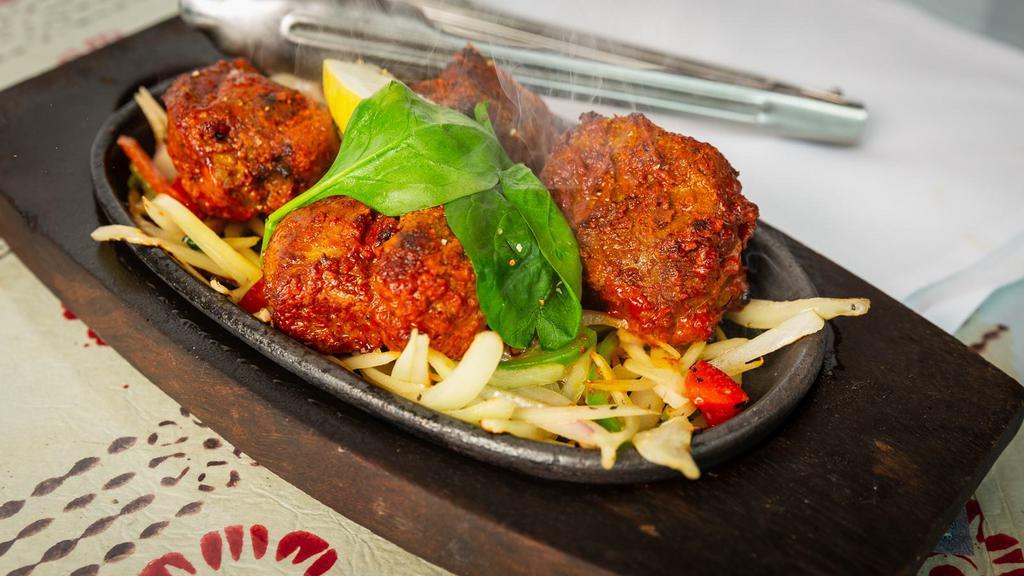 Lamb Boti Kebab · Chunks of boneless lamb marinated with yogurt and a house blend of spices.cooked in a clay oven