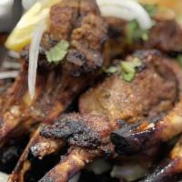 Tandoori Lamb Chop · 4 Pieces of Lamb chops marinated in a blend of spices and barbecued in a clay tandoori oven