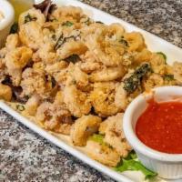 Calamari Fritti · Fresh squid, fried and tossed in garlic-lemon spices, served with cocktail sauce