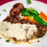 Rib eye steak alla Griglia · Grilled steak served with, Gorgonzola cheese cream sauce, vegetables and potatoes