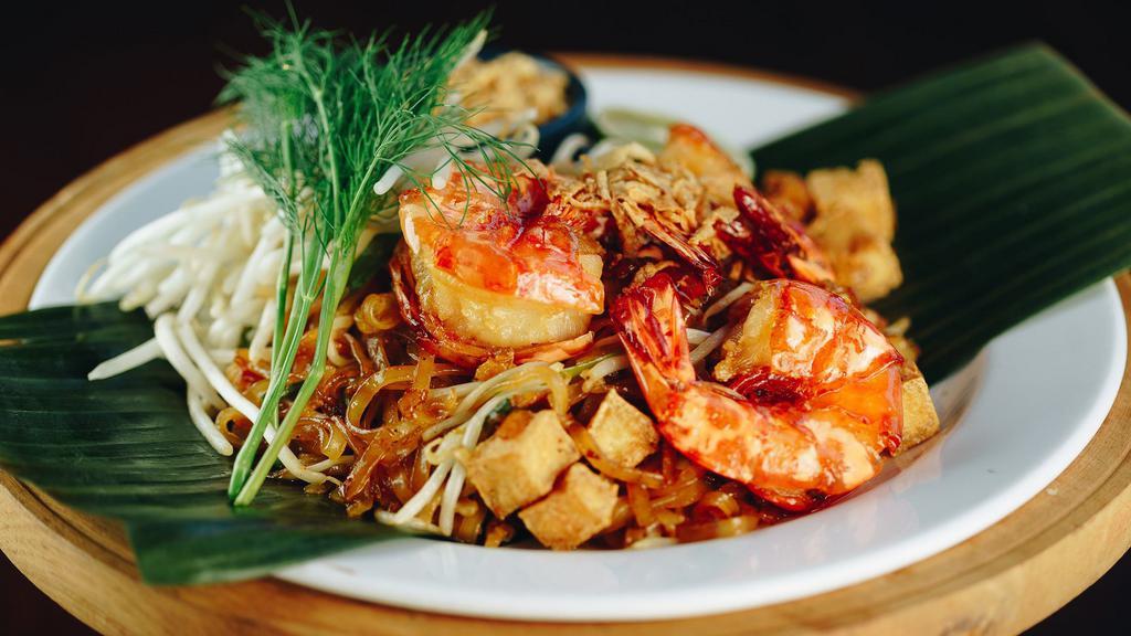 Pad Thai · Stir-fried noodles with eggs, bean sprouts, chives, tofu, crushed peanuts, and your choice of meat.
