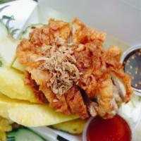 Aloha Fried Chicken · Fried Chicken topped with fired shallots served with fresh pineapple meat  in pineapple. Com...