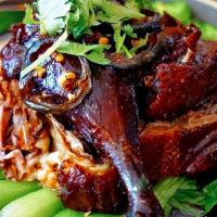 Khao Na Ped · Roasted duck served with jasmine rice, boo toy, caramel egg, homemade soy vinegar sauce, and...