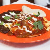 Huevos Rancheros · Two eggs scrambled with black bean chili, housemade ranchero sauce, cheddar cheese and sour ...