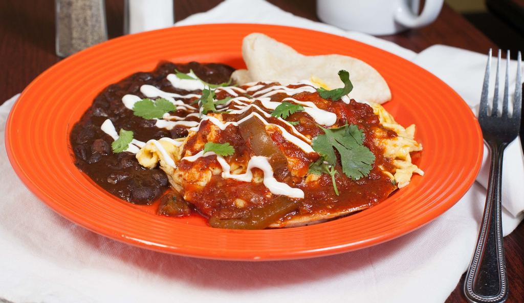Huevos Rancheros · Two eggs scrambled with black bean chili, housemade ranchero sauce, cheddar cheese and sour cream. Served with warm tortillas.