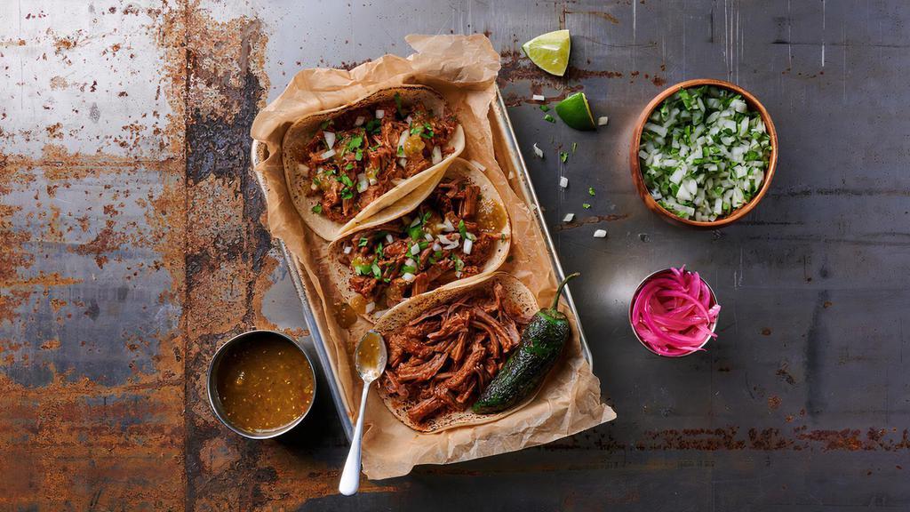 La Chingona · Our badass tacos with slow-cooked, shredded protein of your choice, fresh diced onion & cilantro, salsa verde, pickled onions, roasted jalapeños, served with authentic masa corn tortillas & fresh lime wedges