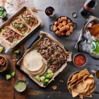 La Gran Reunión (Served Family Style) · Enough tacos for everyone; slow-cooked, shredded protein of your choice; diced onion, fire-r...