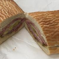 The Muffalata Sandwich · Ham, mortadella, salami, capicola, provolone, olive spread, italian dressing and marinated p...