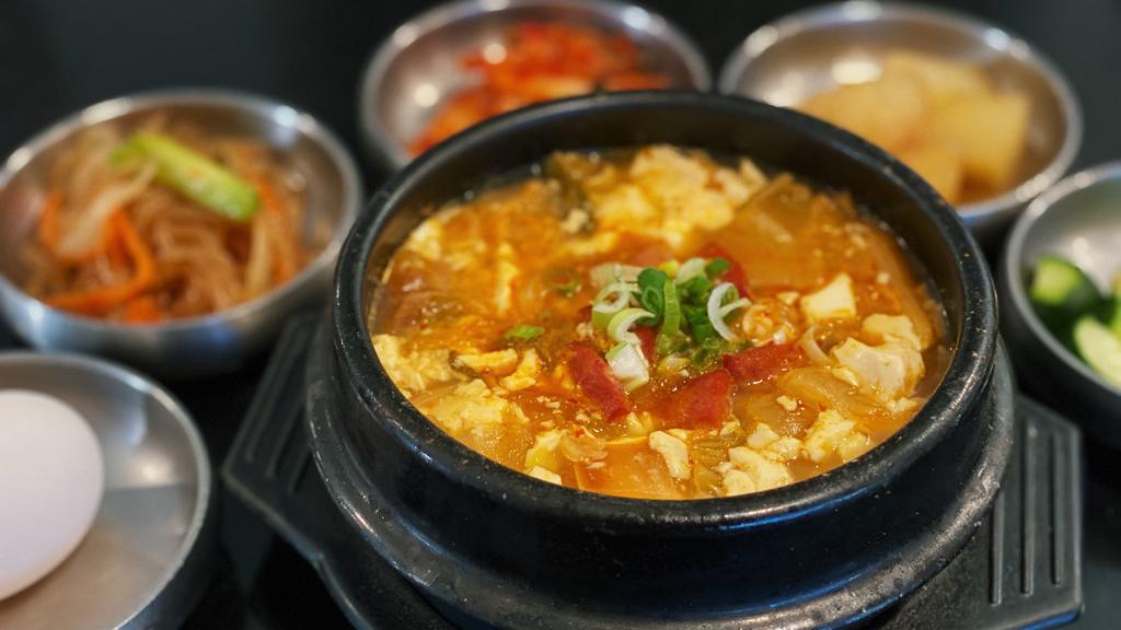 T8. Kimchi Soft Tofu Soup · Organic Tofu boiled with kimchi and beef or pork.