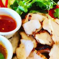 Koor Moo Yang · Overnight marinated grilled pork neck, served with flavorful dipping sauce, seasonal vegetab...