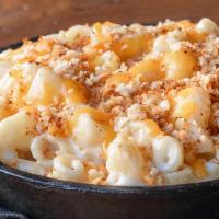 Melty Mac · Our custom cheese blend melted to creamy brilliance, topped with cheddar and toasted bread c...