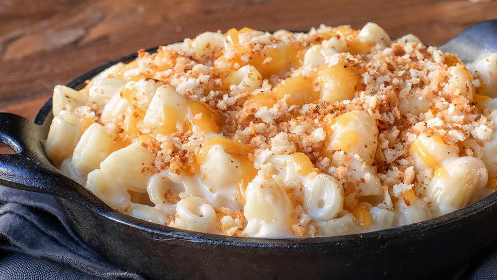 Melty Mac · Our custom cheese blend melted to creamy brilliance, topped with cheddar and toasted bread crumbs