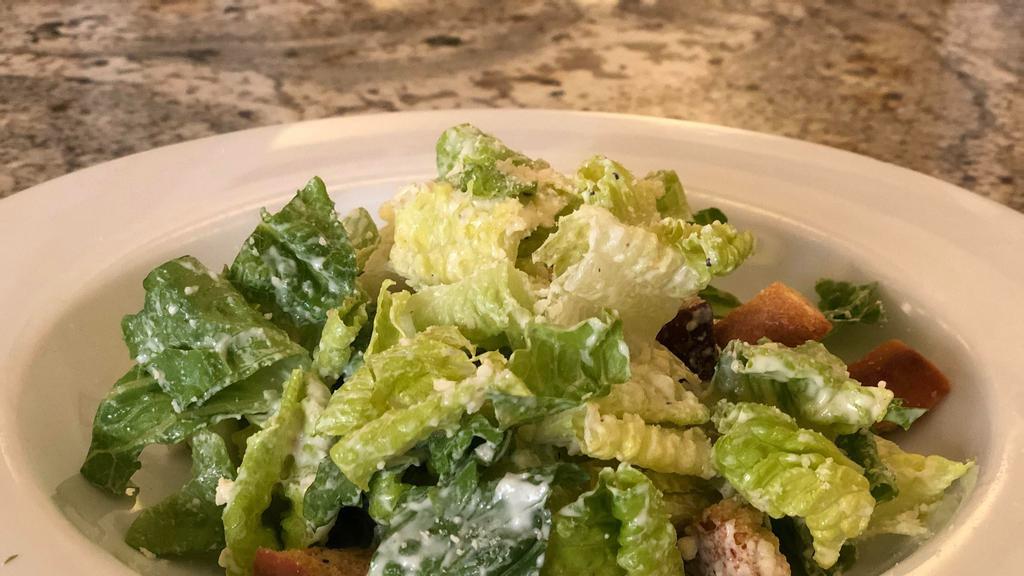 Caesar · Romaine lettuce, parmesan reggiano, garlic croutons and house dressing.