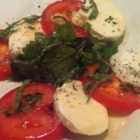 Caprese · Fresh organic tomatoes and buffalo mozzarella, garlic and extra virgin olive oil dressing.