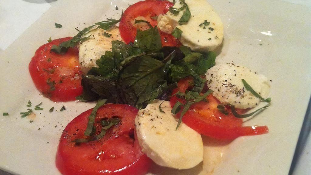 Caprese · Fresh organic tomatoes and buffalo mozzarella, garlic and extra virgin olive oil dressing.