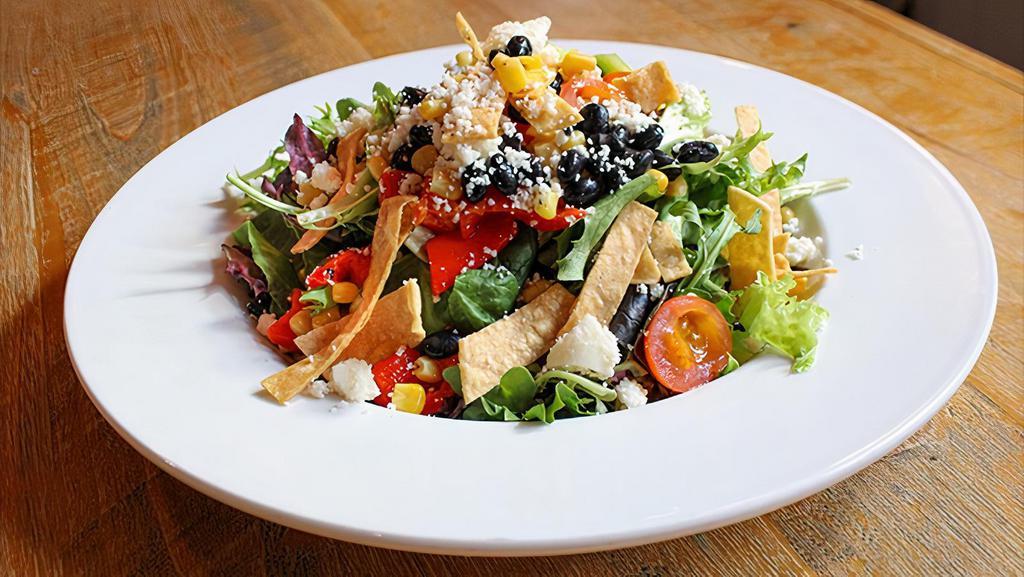 Southwest · Mixed greens, black beans, roasted corn, crispy tortilla strips, cherry tomatoes, cucumbers, roasted red peppers, queso fresco