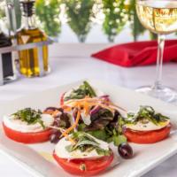 Caprese Salad · Sliced tomato, fresh mozzarella, fresh basil, and olive oil