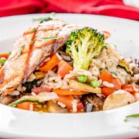 Risotto al Salmone · Italian Arborio risotto sautéed with fresh vegetables served top grilled salmon fillet (3.5 ...