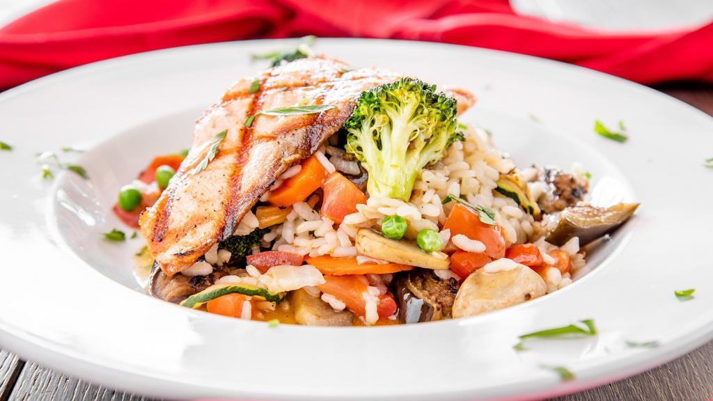 Risotto al Salmone · Italian Arborio risotto sautéed with fresh vegetables served top grilled salmon fillet (3.5 oz)